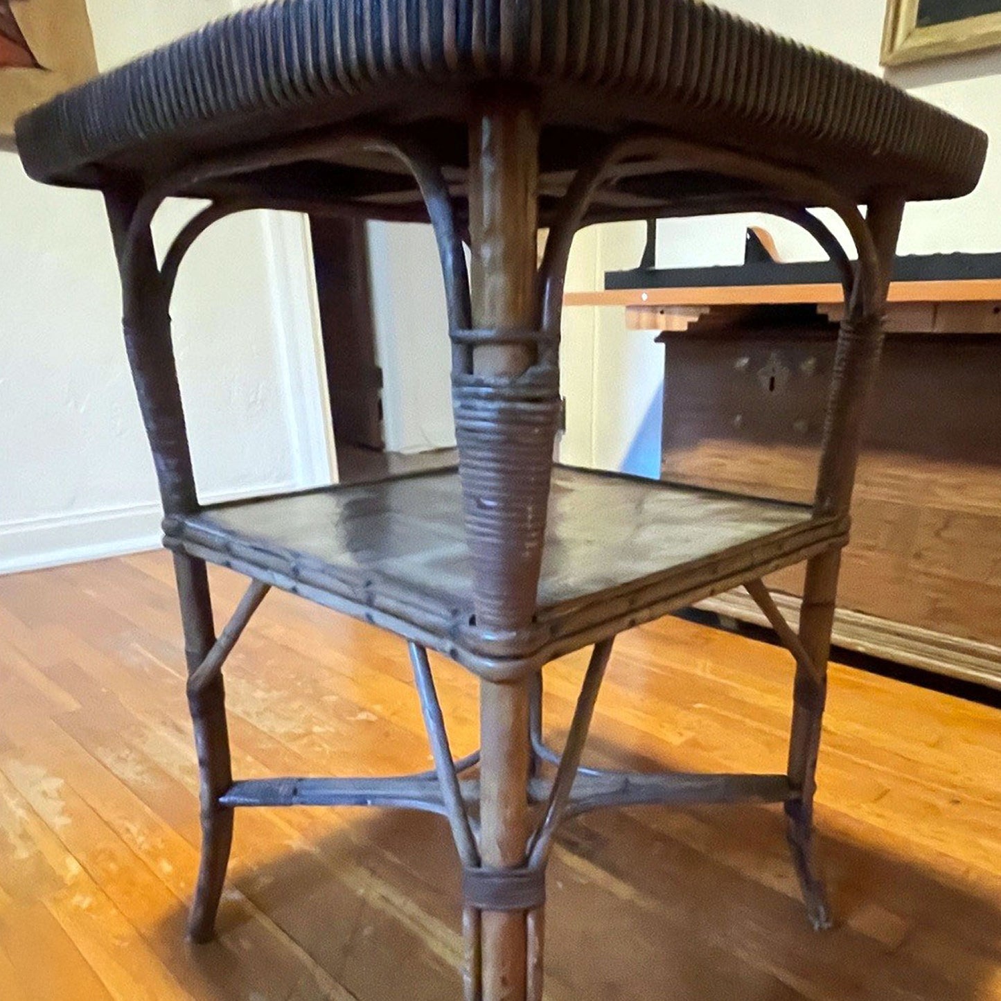 Wooden table leg showing missing trim on a wooden floor