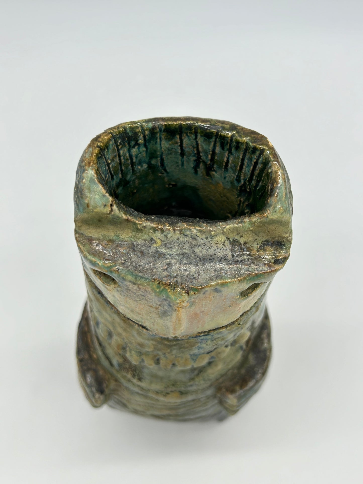 top rim view of Small Statue of a creature with mottled green glaze
