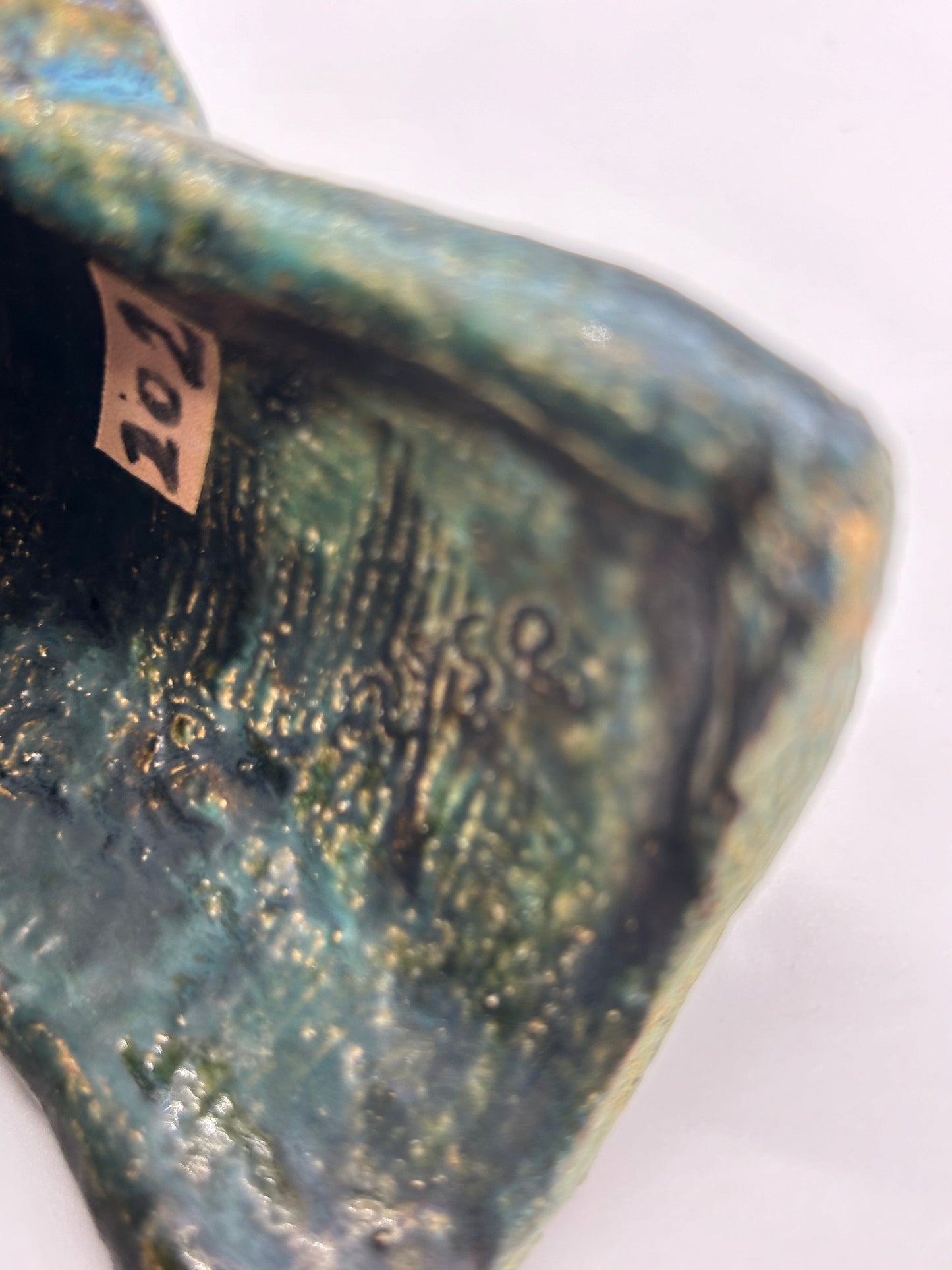 artist hallmark for Small Statue of a creature with mottled green glaze