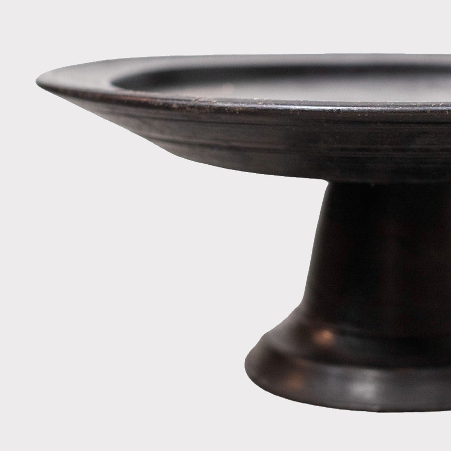 close up of ebonized wood footed pedestal bowl