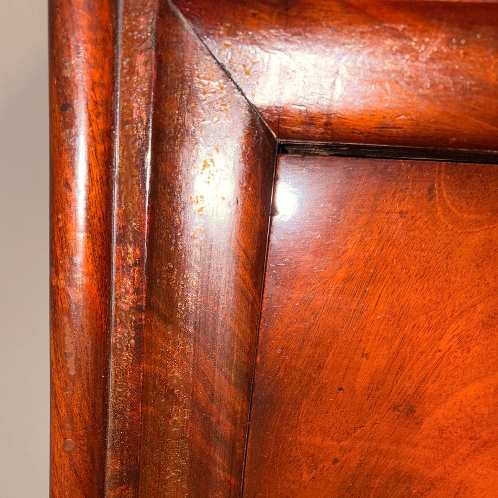 Close up image of the corner of a wooden cabinet